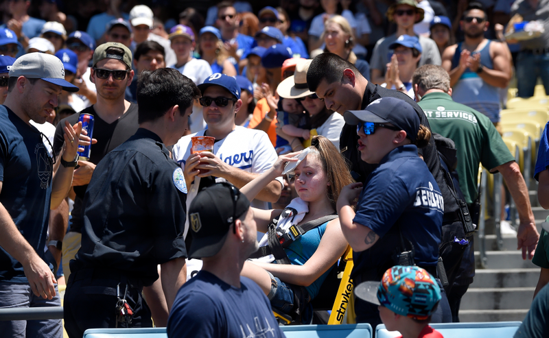 A young fan is carted away after being hit with a foul ball hit by Los Angeles Dodgers’ Cody Bellinger during the first inning of a baseball game against the Colorado Rockies, Sunday, June 23, 2019, in Los Angeles.
